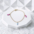 Bracelet doré breloques hippocampes rose/bleu