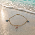 Bracelet doré étoiles de mer rose/bleu